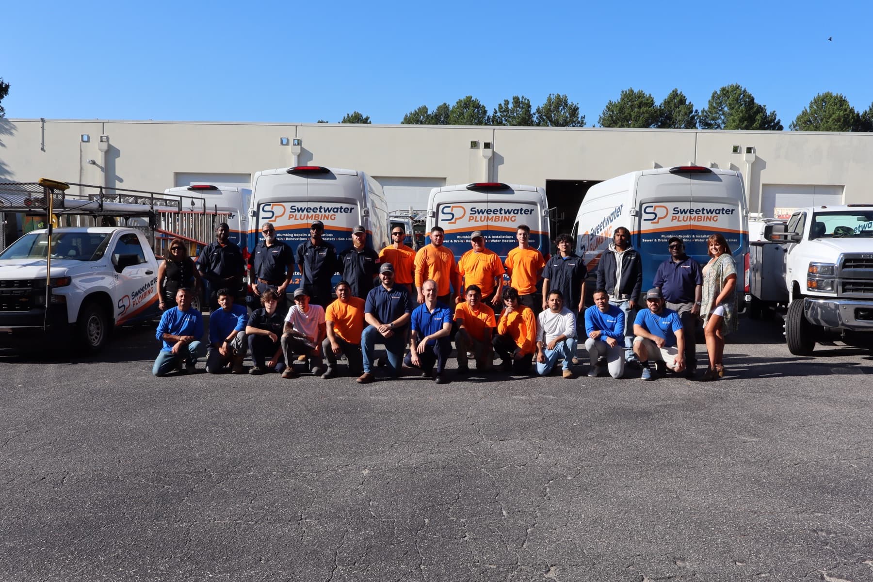 The Sweetwater Plumbing team in front of the company fleet