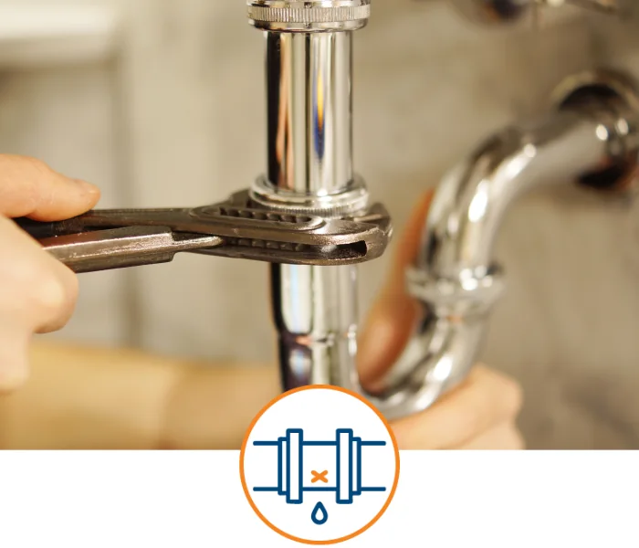 Hands tightening a sink drain pipe